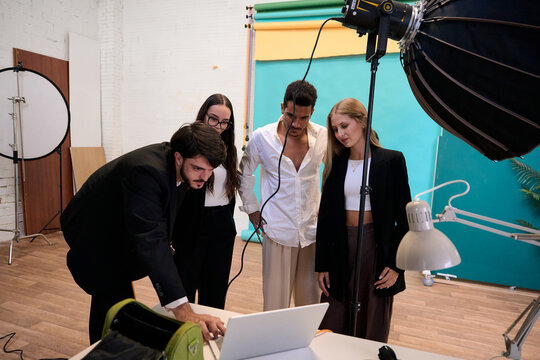 Creative team reviewing results during a studio photoshoot - Powered by Adobe