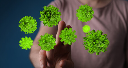 Digitally rendered green viruses interacting with a human finger, representing scientific and medical concepts