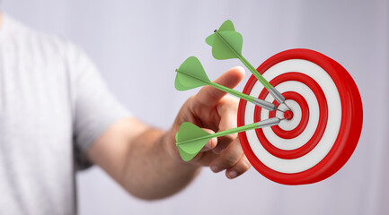 Image of a hand throwing darts and achieving the goal in the target successfully. Concept of...