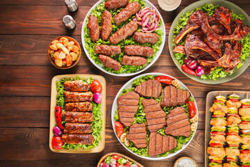 Arabic Cuisine; A variety of grilled meat dishes such as grilled fillet, ribs, kofta, tarb and shish tawook. Served with delicious side dishes. Top view with close up.