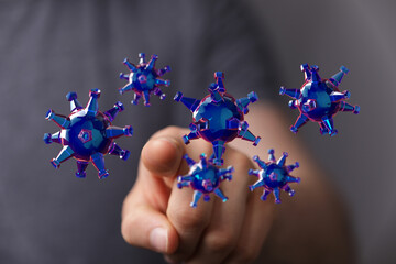 3D render of a hand pointing at a group of digitally created coronavirus cells symbolizing the pandemic and as