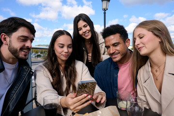 Diverse friends sharing content on a mobile phone