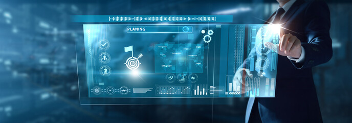Businessman analyzing Planning data on virtual interface goal mapping, strategic direction, project timelines, workflow design, business priorities.
