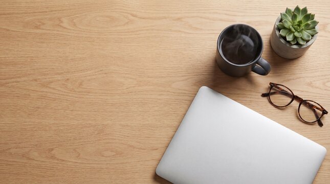 Top view of modern office desk with closed silver laptop, steaming coffee cup, eyeglasses, succulent plant, and smooth wooden texture workspace - Powered by Adobe