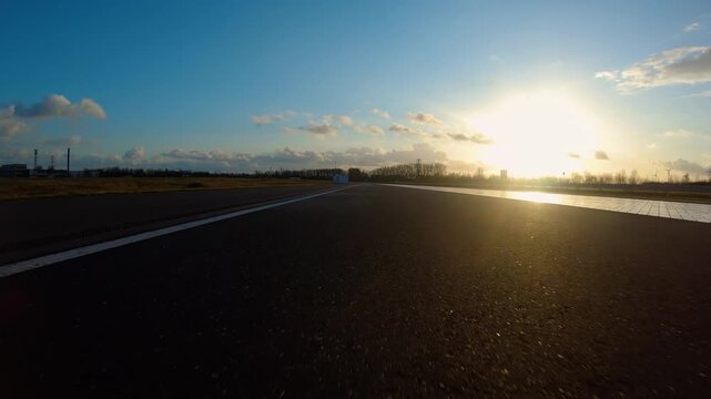 driving a Race Car on a racetrack on a sunny day. POV view