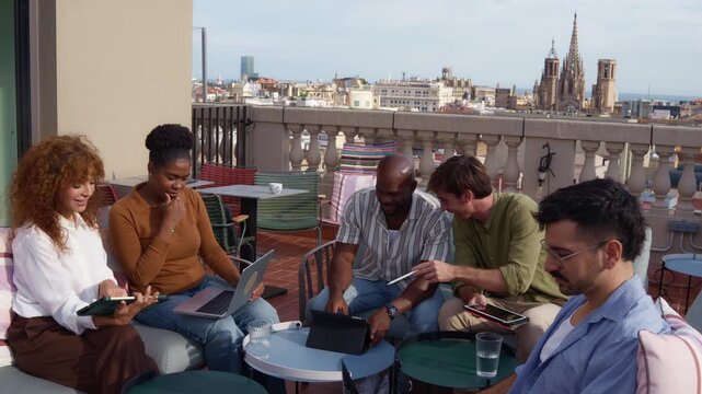 Diverse creative team collaborating on a rooftop terrace in barcelona