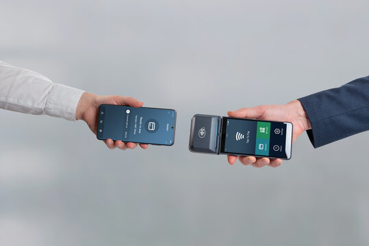 Smartphone ready to pay facing mobile POS terminal, representing contactless payment interaction, wireless transaction, and modern cashless checkout technology
