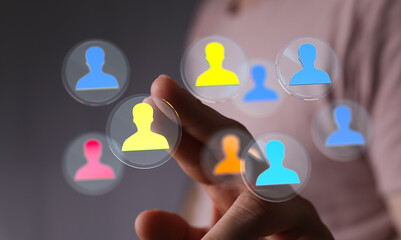 Concept of networking, recruitment, human resources. Hand interacting with a network of people icons. Teamwork, connection, community.