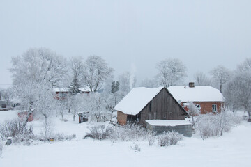 A fantastic winter landscape on the outskirts of the city in a snowy forest. An old house.
