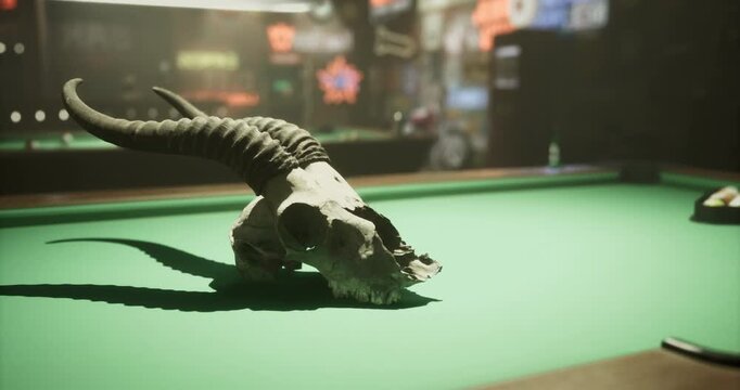 A skull with prominent horns rests on a green billiard table in a bar. The low lighting creates a moody ambiance, while background activities suggest a lively environment.