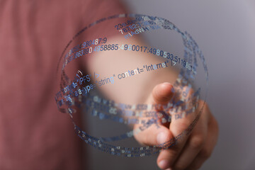 A person's finger pointing at a digital sphere with data and code, symbolizing technology, internet and connection.