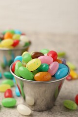 Delicious colorful candies on grey table, closeup. Space for text