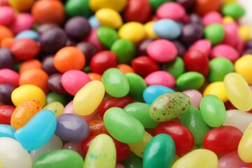 Many delicious colorful candies as background, closeup