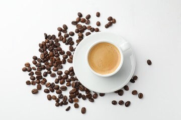 Cup of aromatic coffee and roasted beans on white background, flat lay