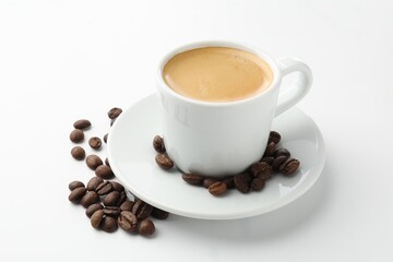 Cup of aromatic coffee and roasted beans on white background, closeup