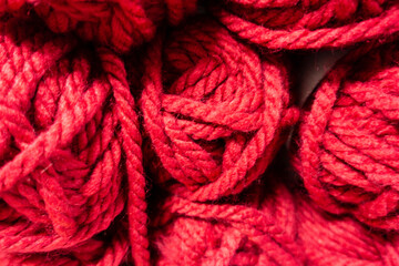 Double knitting wool in bright red  piled together for sale for knitting crocheting and crafting.