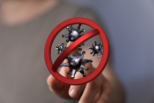 Concept image of a hand interacting with a 'Stop Coronavirus' sign. Symbolizes global pandemic control and mea