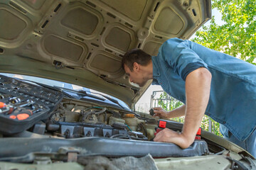 Man check broken car and open bonnet outdoor