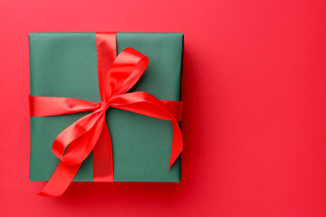 Beautiful gift box on red background, top view. Space for text