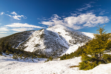 Snow-capped mountain peak under a blue sky. The Velky Krivan peak in The Mala Fatra national park, Slovakia, Europe.
