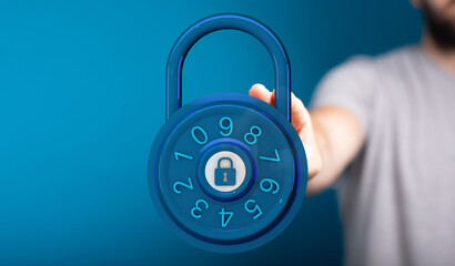 Close-up of a hand holding a blue combination lock, perfect for illustrating concepts of security, protection,