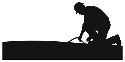 Silhouette of a construction worker kneeling and working Keywords: construction, worker, silhouette, kneeling, working, industry