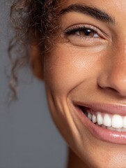 Fototapeta premium close up face of young woman with beautiful smile isolated on grey wall with copy space successful multiethnic girl latin woman looking at camera against gray wall with a big whitening teeth smile no