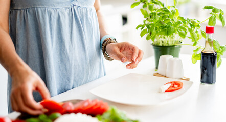 Close-Up Of Woman Making Caprese Salad