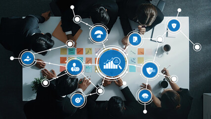 Aerial view of a business meeting with a diverse team collaborating on strategies and concepts, featuring visual data analysis tools, sticky notes, and innovative ideas. Amity