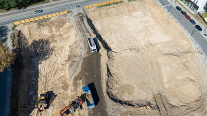 Aerial View of Construction Site with Excavators and Trucks