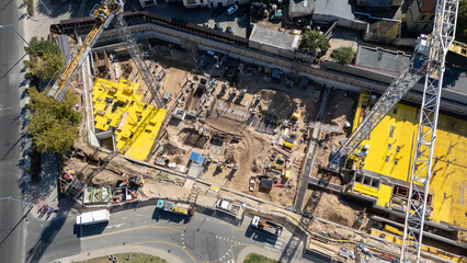 Aerial View of Construction Site with Cranes and Machinery