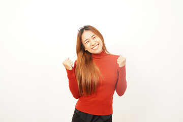 Extremely happy young woman with both fists clenched and arms bent, expressing strong success, excitement, or victory.