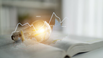 An artistic representation of a light bulb on an open book, highlighting trends and graphs to symbolize creativity and knowledge in business innovation and financial growth. Scalp © InfiniteFlow