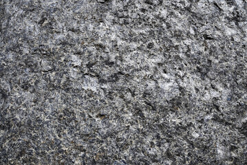 Natural stone wall texture in gray tones. Rough rocky surface, detailed mineral pattern, abstract natural background suitable for architecture, geology, industrial and minimal design.