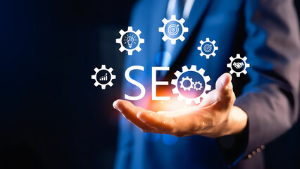 Businessman presenting seo concept with glowing gears and symbols in hand