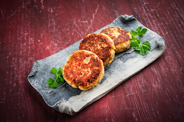 Kaspresskn&ouml;del - traditional Austrian fried cheese bread dumplings served as close-up on a design plate