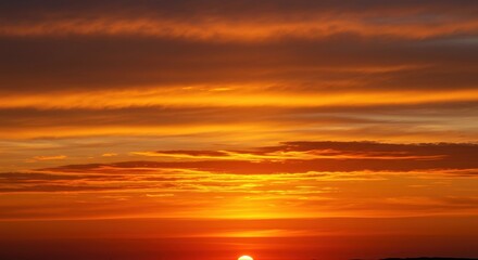 Fototapeta premium Vibrant orange sunset illuminating wispy clouds high above the horizon, creating a warm, dramatic atmospheric display ,horizon ,serene ,vibrant