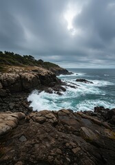Obraz premium Dramatic panoramic view of a rugged, pristine coastline where powerful ocean waves crash against ancient stones, emphasizing wild natural beauty ,horizon ,seaside ,clouds