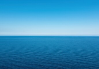 Obraz premium Expansive view of the deep blue ocean water meeting the clear sky at the distant horizon, creating a peaceful, vast seascape panorama ,turquoise ,seascape ,tropical