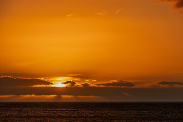 Sunset in the ocean. Abstract orange landscape with the sun setting over the sea