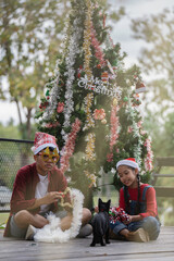 The children are celebrating Christmas and decorating the Christmas tree together.