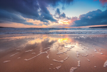 Beautiful sunrise over the sea horizon and beach shore