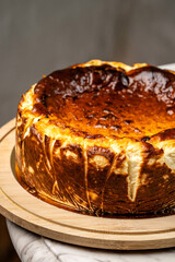 Basque burnt cheesecake on wooden serving board