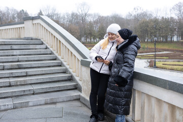Meeting two friends, chatting and walking in the park