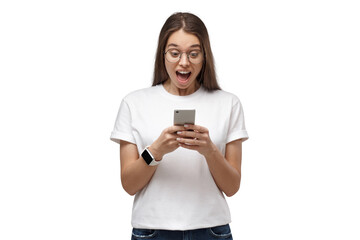 Fototapeta premium Excited young woman with an open mouth expression, reacting with surprise to content on her phone
