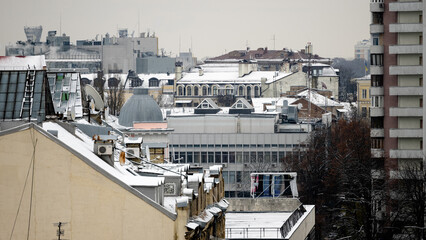 Fototapeta premium Modern and historical buildings in snowy city center