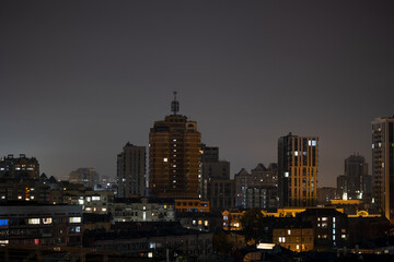 Obraz premium Illuminated residential districts under dark night sky