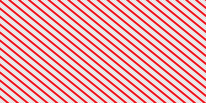 Red and pink Christmas seamless pattern. Candy cane diagonal stripes background. Repeating decoration wallpaper. Winter holidays lines backdrop. Xmas peppermint present wrapping print design. Vector