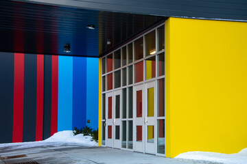 The exterior entrance to a building with two double glass aluminum doors. The modern-style building...