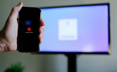 Middle Aged Man Working From Home Remotely is Prompted for Multi Factor Authentication Approval While Signing In Work Computer Cybersecurity Concept